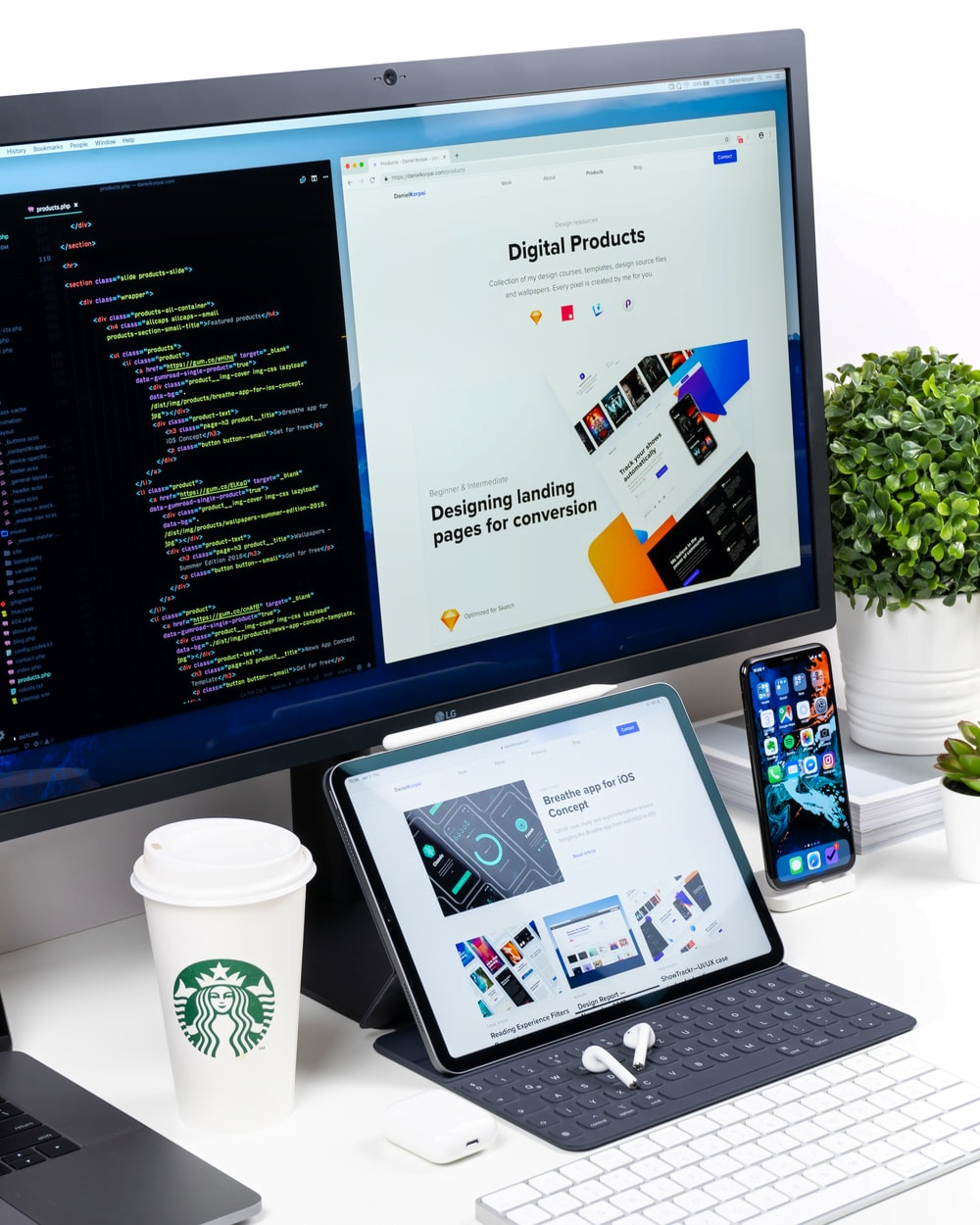 A Starbucks To-Go Cup Beside a Monitor Screen Showing a Web Designer for eCommerce Working on the PC, Mobile, and Tablet Versions of a Website 